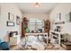 Bright home office features a large desk, shelving and natural light from the window at 21985 E Bailey Pl, Aurora, CO 80016