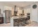 Bright kitchen boasts stainless steel appliances, granite countertops, island with bar seating, and stylish pendant lighting at 21985 E Bailey Pl, Aurora, CO 80016