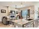 Open-concept living space featuring a fireplace, large window, and seamless flow into the kitchen, perfect for modern living at 21985 E Bailey Pl, Aurora, CO 80016