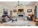 Comfortable living room with a fireplace, ceiling fan, and stylish furnishings, creating a welcoming space to relax at 21985 E Bailey Pl, Aurora, CO 80016