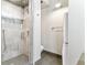 Sleek walk-in shower with glass door and gray stone tile, plus adjacent laundry area at 2000 Arapahoe St # 305, Denver, CO 80205