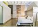 Modern bedroom with exposed brick, wood, concrete details and Murphy bed for flexible space at 2000 Arapahoe St # 305, Denver, CO 80205