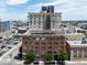 Exterior shot highlighting a commercial building, adjacent parking and the surrounding cityscape at 2000 Arapahoe St # 305, Denver, CO 80205