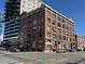 A street-level exterior view of commercial building with many windows, showcasing its urban location at 2000 Arapahoe St # 305, Denver, CO 80205