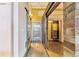 Inviting hallway with hardwood floors and rustic wood accents, leading to a closet space and flooded with natural light at 2000 Arapahoe St # 305, Denver, CO 80205