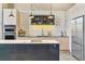 Stylish kitchen with modern appliances, unique backsplash, and ample cabinet space offering both beauty and functionality at 2000 Arapahoe St # 305, Denver, CO 80205