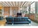 Inviting living room area with exposed brick walls and a stylish couch at 2000 Arapahoe St # 305, Denver, CO 80205