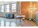 Well-lit office space featuring hardwood floors, exposed brick, and a large window at 2000 Arapahoe St # 305, Denver, CO 80205