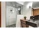 Modern bathroom featuring a stone pebble floor, glass shower, and unique stone basin sink at 1030 S Adams St, Denver, CO 80209