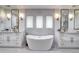 Luxury bathroom showcasing a standalone tub and dual vanity with a minimalist design at 1030 S Adams St, Denver, CO 80209