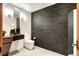 Contemporary bathroom with sleek black accents, modern fixtures, and unique tile work, creating a stylish space at 1030 S Adams St, Denver, CO 80209
