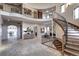 Expansive foyer showcasing wrought iron railings, a curved staircase, and an open layout with travertine flooring at 1030 S Adams St, Denver, CO 80209