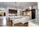 Open concept kitchen with a marble island, ample counter space, and custom cabinetry with glass doors at 1030 S Adams St, Denver, CO 80209