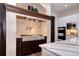 Close-up of the kitchen with stainless steel range, custom hood, and a marble-topped island at 1030 S Adams St, Denver, CO 80209