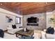 Comfortable living room highlighted by a stone accent wall with a fireplace and a stylish wooden ceiling at 1030 S Adams St, Denver, CO 80209