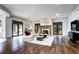 Open living room with hardwood floors, modern fireplace, and large windows at 1030 S Adams St, Denver, CO 80209