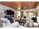 Living room with a stone accent wall, cozy seating, and a wooden ceiling, creating a stylish and inviting space at 1030 S Adams St, Denver, CO 80209