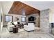 Cozy living room featuring a stone accent wall with fireplace and TV, plus herringbone floors and a wooden ceiling at 1030 S Adams St, Denver, CO 80209