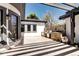Well-appointed outdoor kitchen area with stone accents and shade from a pergola at 1030 S Adams St, Denver, CO 80209