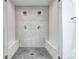 Modern walk-in shower featuring dual shower heads and built-in seating at 1030 S Adams St, Denver, CO 80209