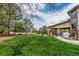 Lush backyard with a covered patio, outdoor seating, and mature trees offering a serene and private outdoor space at 6391 S Malaya St, Centennial, CO 80016