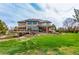 Large backyard with a covered patio, a spacious deck, and mature landscaping creates a private oasis at 6391 S Malaya St, Centennial, CO 80016