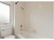 Clean bathroom with a tiled shower-tub combo and bright window, providing a functional and refreshing space for personal care at 6391 S Malaya St, Centennial, CO 80016