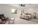 Comfortable bedroom featuring ample natural light from large windows, complemented by stylish furnishings for a relaxing atmosphere at 6391 S Malaya St, Centennial, CO 80016