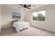Cozy bedroom with a large window, ceiling fan, and beach-themed artwork at 6391 S Malaya St, Centennial, CO 80016