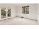 Bright bedroom with fresh paint, chair railing, carpet, and a sliding glass door to the deck at 6391 S Malaya St, Centennial, CO 80016