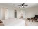 Well-lit bedroom with a ceiling fan, offering easy access to the bathroom, closet, and hallway for added convenience at 6391 S Malaya St, Centennial, CO 80016