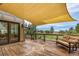 Spacious outdoor deck with partial shade cover, patio furniture, and beautiful backyard views for outdoor relaxation at 6391 S Malaya St, Centennial, CO 80016