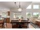 Open concept living space with a large dining table, hardwood floors, and lots of natural light at 6391 S Malaya St, Centennial, CO 80016