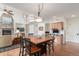 Open concept dining area featuring a beautiful fireplace and hardwood floors at 6391 S Malaya St, Centennial, CO 80016