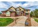Attractive two-story home with brick and stucco exterior, professional landscaping, and inviting front entrance at 6391 S Malaya St, Centennial, CO 80016