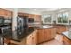 Spacious kitchen with granite countertops, wood cabinets and stainless steel appliances at 6391 S Malaya St, Centennial, CO 80016