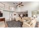 Open concept living room with soaring ceilings, hardwood floors, and views of the second-floor landing at 6391 S Malaya St, Centennial, CO 80016