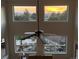 Bright living room with large windows offering views of the backyard and a beautiful sunset at 6391 S Malaya St, Centennial, CO 80016