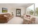 Cozy sitting room with comfortable seating, display case, and large windows with scenic views at 6391 S Malaya St, Centennial, CO 80016