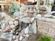 Beautiful backyard rock water feature with cascading waterfalls adding a touch of nature and tranquility to the landscape at 6391 S Malaya St, Centennial, CO 80016