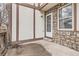 Charming back porch with stone accents, white door, and window allowing for natural light at 17936 Becket Dr, Parker, CO 80134