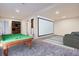 Finished basement featuring a pool table and a large screen projector at 17936 Becket Dr, Parker, CO 80134
