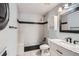 Bathroom featuring a marble-top vanity, white cabinets, and a tile shower with black accents at 17936 Becket Dr, Parker, CO 80134
