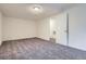 This bedroom offers a blank canvas with soft carpet, a bright neutral paint, and a doorway at 17936 Becket Dr, Parker, CO 80134