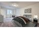 This bedroom features neutral decor, a comfortable bed, and soft natural light through a window at 17936 Becket Dr, Parker, CO 80134