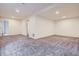 A spacious bedroom provides a blank canvas with soft carpet, a window, and a bright neutral paint at 17936 Becket Dr, Parker, CO 80134