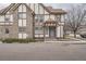 Street view of a Tudor-style townhome with stone accents and a welcoming entrance at 17936 Becket Dr, Parker, CO 80134