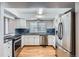 Modern kitchen featuring stainless steel appliances, granite countertops, and white cabinetry at 17936 Becket Dr, Parker, CO 80134