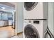 A convenient laundry area features a stacked washer and dryer and offers access to the kitchen at 17936 Becket Dr, Parker, CO 80134