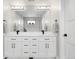 Bright bathroom featuring a double vanity with black hardware and a large mirror at 2231 W 36Th Ave, Denver, CO 80211